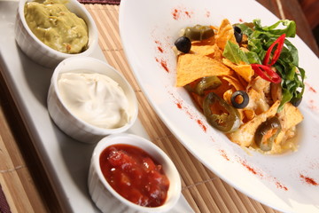 Salad with nachos and sauce guacamole