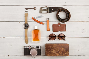 travel concept - set of cool stuff with camera and other things on wooden table