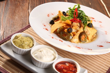 Salad with nachos and sauce guacamole