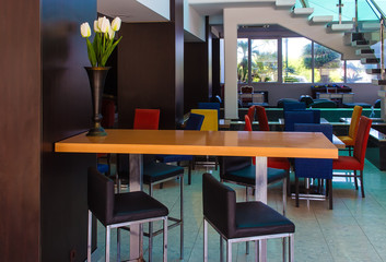 Interior of modern hotel with staircase and high chairs