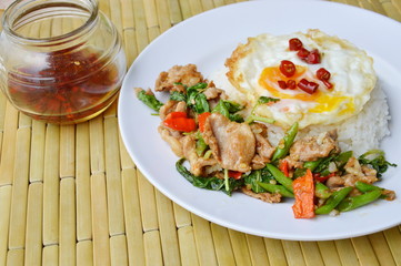 spicy stir fried pork with basil leaf and egg on rice