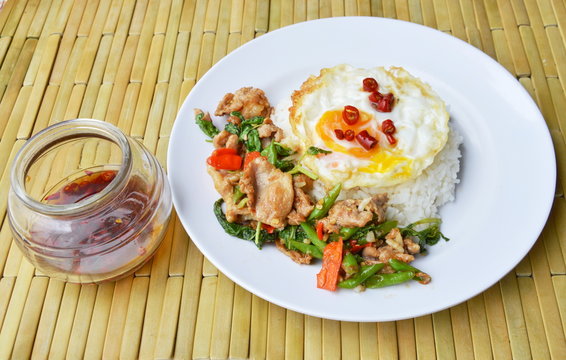 spicy stir fried pork with basil leaf and egg on rice