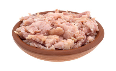 Small bowl of smoked ground ham side view isolated on a white background.