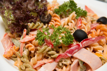  white dish with a salad of pasta and prawn.