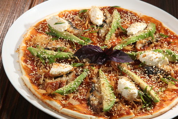 Pizza with avocado and cumin