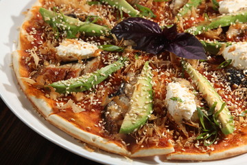 Pizza with avocado and cumin