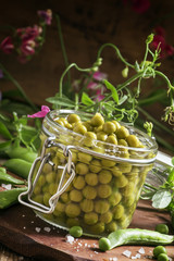 Canned sweet peas in a glass jar, fresh peas, preparation, selec