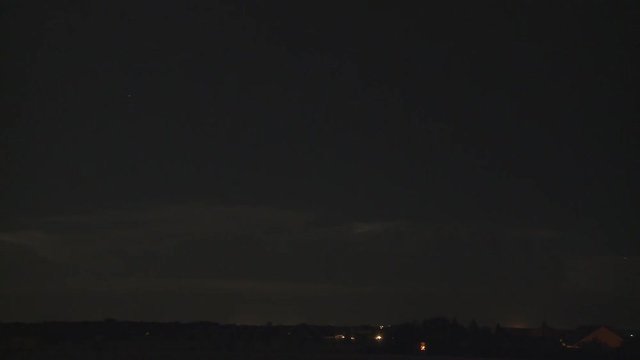 Time-lapse night thunderstorm over a rural community