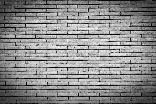 Black and white brick wall texture. Brick wall background for design. Closeup brick texture. Grunge retro vintage of brick wall. Part of brick wall with copy space for text or image. Dark edged.