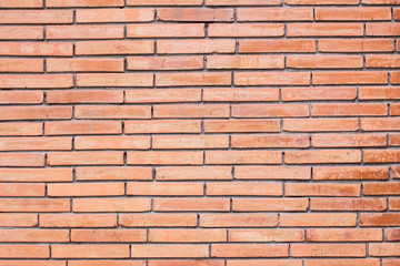 Fototapeta premium Orange brick wall texture. Brick wall background for design. Closeup brick texture. Grunge retro vintage of brick wall. Part of brick wall with copy space for text or image.