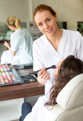 Obraz premium Two young beautician students working during make up classes