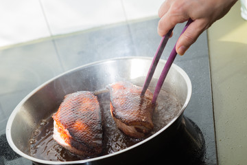 Duck fillet on grille pan. Poultry meat prepared on a grill. Fresh, delicious, spicy dish on a kitchen with copy space closeup and copy space.
