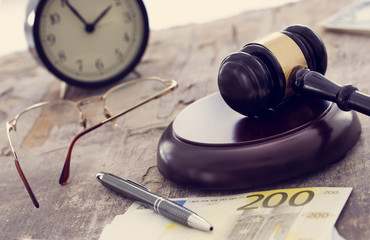 Law concept, gavel, clock and money on wooden table