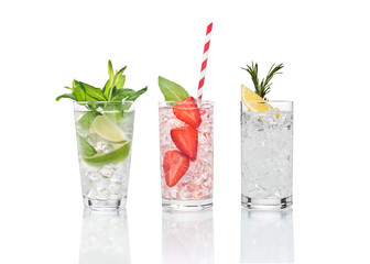Summer cocktails are on the glass surface.