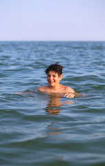 boy  plays in seawater during summer vacation
