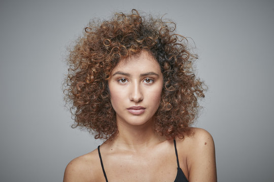 Portrait of redheaded woman with curly hair