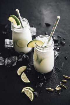 Homemade coconut milk flavoured with syrup, cardamom and lime