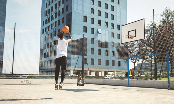 Young man aiming at basketball hoop