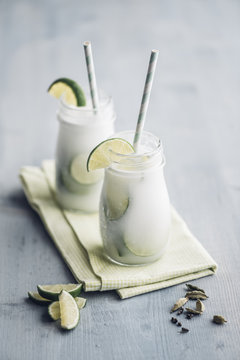 Homemade coconut milk flavoured with syrup, cardamom and lime