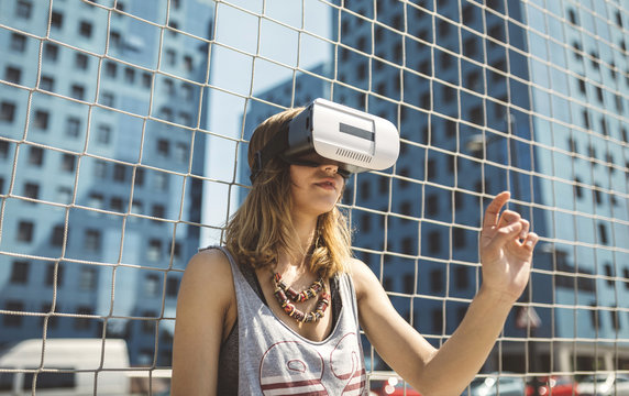 Young woman using virtual reality glasses