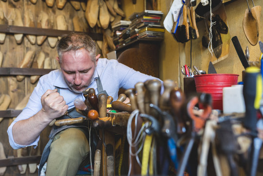 Cobbler making shoes in his workshop