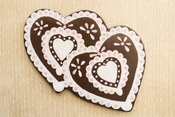 Fake gingerbred hearts on beige background
