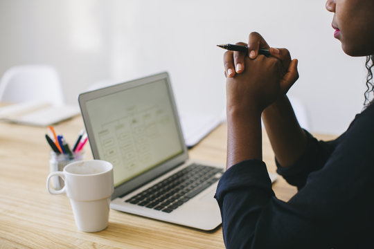 Young woman in office sitting in front of laptop