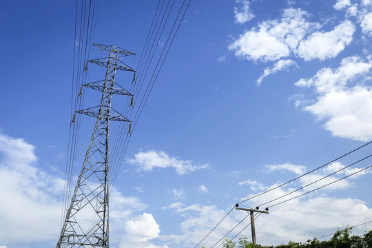 High voltage electric pole with and city electric pole in summer sunny day blue sky