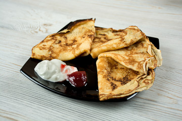 Pancakes with sour cream and strawberry jam