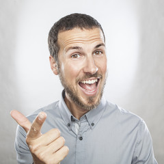 Fototapeta premium portrait of a young beautiful man smiling, face expression
