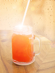 Soft and blur glass of strawberry soda summer beverage with soft light on wood table