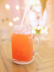 Soft and blur glass of strawberry soda summer beverage with soft light on wood table