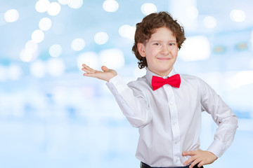Boy in shirt pointing with his palm