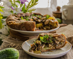 Cut a piece of pie(rye biscuit) with mushrooms, potatoes 