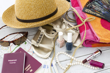 Travel concept. Travel accessories, straw hat, passport and money on wooden table 