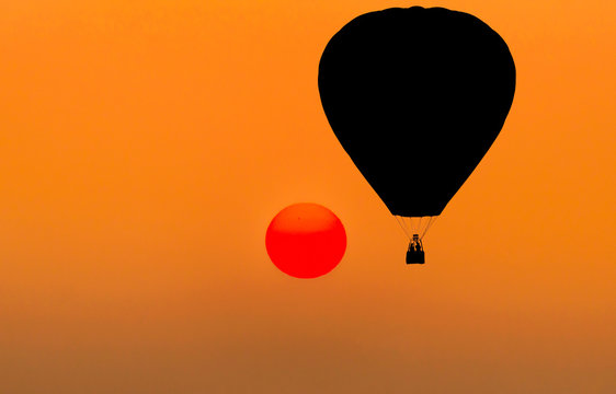 silhouette hot air balloons floating on sunset background 
