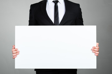 Businessman holding blank picture frame