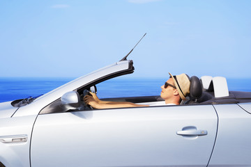 Young man drive a car on the beach