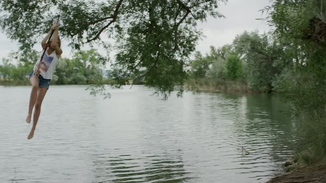 Wide slow motion panning shot of couple playing at lake / Mona, Utah, United States
