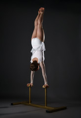 Obraz na płótnie Canvas Gymnastics. Shot of flexible woman doing handstand