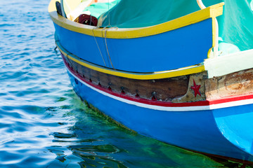 Fototapeta na wymiar Traditional Maltese fishing boat, St Thomas Bay, Marsascala, Mal