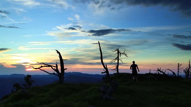 Man trail running in the French Vercors mountains during a nice sunset. Shallow D.O.F.