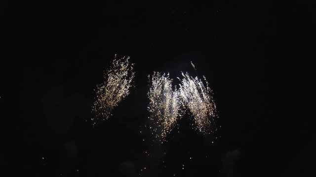Fireworks display with crisscrossing rockets from below frame