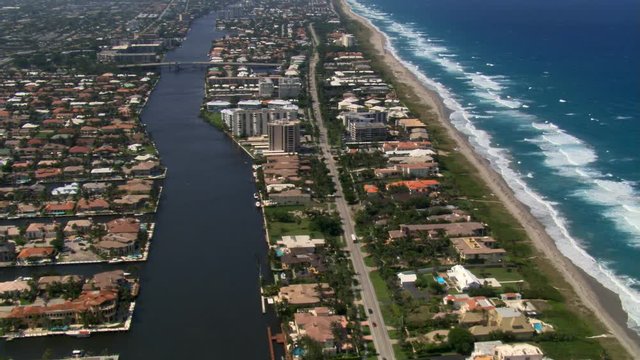 Aerial following channel along Boca Raton, Florida coastline