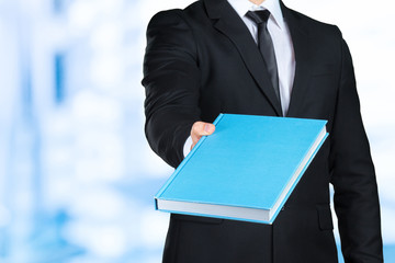 Unrecognizable businessman holding a book closeup