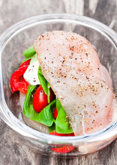 Raw  chicken breast stuffed with mozzarella and vegetables