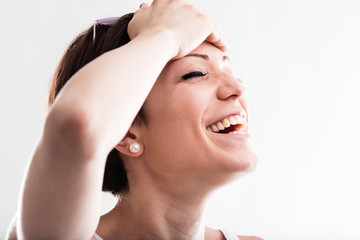 Happy woman laughing with her hand to her head