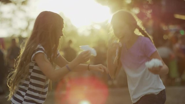 Medium slow motion shot of girls playing with cotton candy / Pleasant Grove, Utah, United States