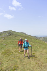 Obraz premium Summer hiking in the mountains with a backpack .