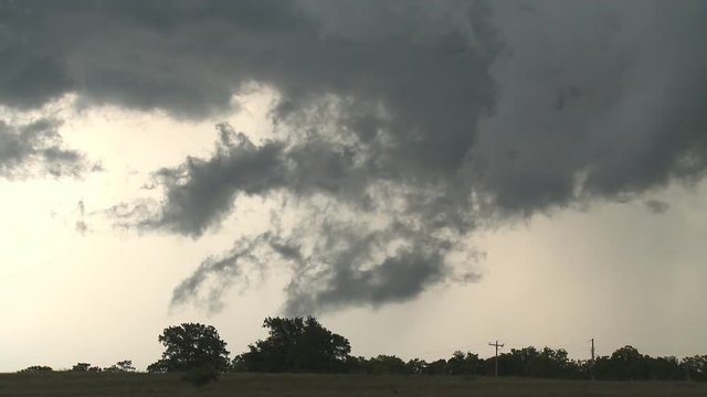 Ragged gray clouds over a rural field